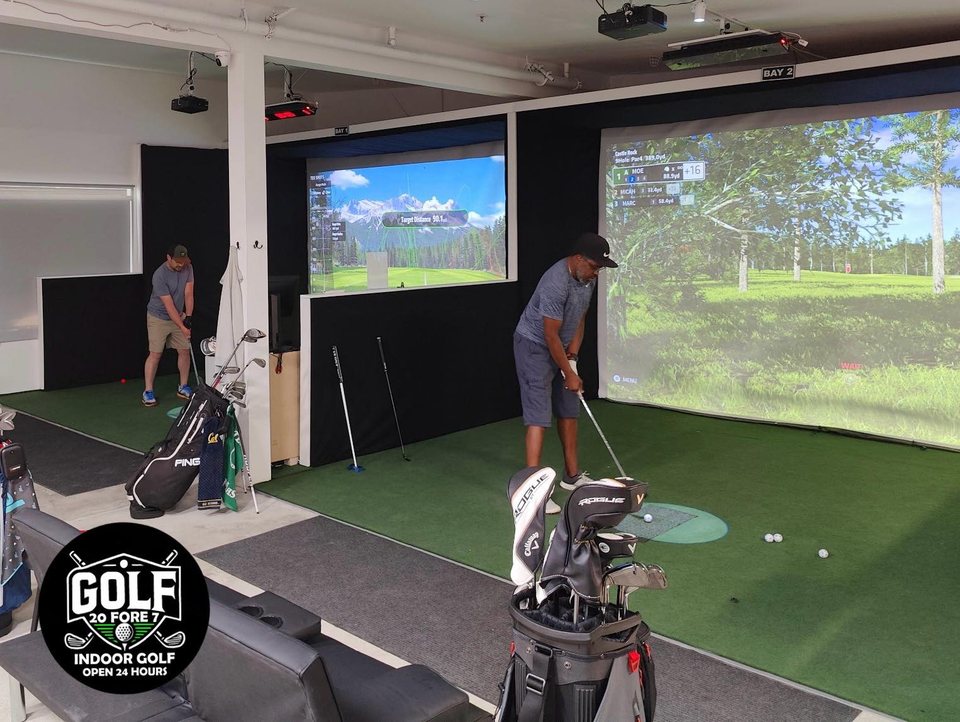 Golfers playing the simulator bays at Golf 20Fore7